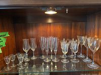Cabinet shelf with assorted stemware groups visible
