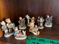 Shelf view showing all eight Hummel figurines