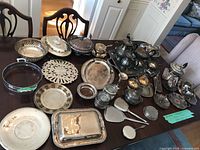 Overall view of assorted silver-plated serveware spread on table