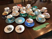 All teacup and saucer sets plus loose saucers displayed on table