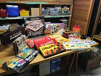 Group shot of all board games, View-Master, poker chips and cribbage board on table