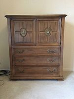 Front view of tallboy dresser showing cabinet doors and drawers