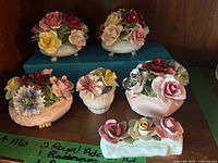 All six Royal Adderley bone china floral figurines displayed on shelf