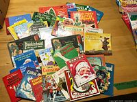 Wide shot of assorted Christmas-themed children’s books spread on table
