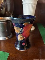 Moorcroft bud vase front view showing fruit motif