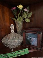 Crystal bowl, crystal vase with roses, wooden Bombay picture box displayed on shelf