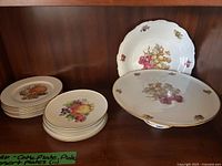 Stack of dessert plates and set overview with serving plate and cake stand