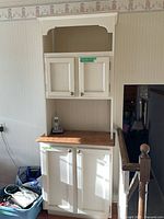 Full view of two-piece tall white cabinet showing upper and lower sections