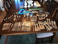 Full table view of flatware assortment laid out by type