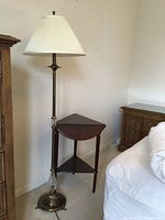 Floor lamp beside table showing overall design and shade