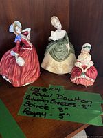 Three Royal Doulton figurines grouped with handwritten dimension notes