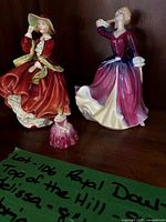 All three Royal Doulton figurines on shelf