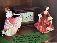 Overall shot of both Royal Doulton figurines and Bombay mantel clock on shelf