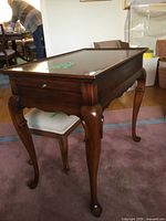 Front view of wooden side table with stool underneath