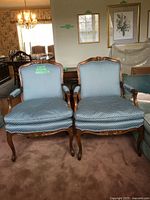 Front view of both matching blue upholstered armchairs