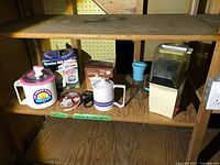 Overview of all appliances on shelf: ice cream maker, hot pot, popcorn maker, glass carafe