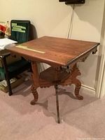 Three-quarter view of entire table showing top, legs and lower shelf