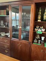 Full view of middle section showing glass doors, lower cabinet doors, adjacent units visible