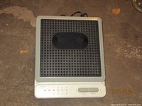 Top view of AcuVibe foot massager showing perforated rubber footpad and control panel