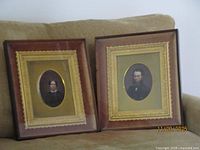 Both framed portraits side by side on sofa