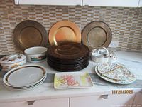 Countertop view of all plates, bowls, stand, caddy, tray