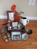 All items grouped on floor for overview, showing pitcher, frame, bowls, tray, figurines, etc.