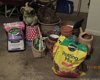 Group shot of pots, soil bags, rabbit statue, watering can and baskets