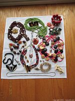 All jewelry pieces laid out on white cloth showing overall variety