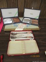 Two boxed sets of steak knives, Royal Crown Derby spoon case displayed open