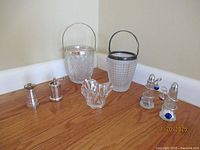 Group shot showing both ice buckets, pepper mill, salt shaker, crystal bowl, and shaker set in stand