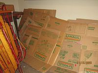 Stack of flattened U-Haul boxes against wall