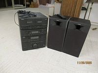 Full view of stacked KC-103 and R-103 units with speakers and remote