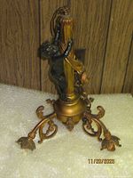 Full view of chandelier showing cherub figure and scrolling arms