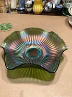 Top view showing iridescent interior, Stippled Rays pattern and scalloped edge