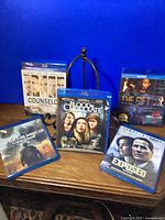 Group shot of all five Blu-ray cases standing and lying on table