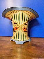 Front view of Noritake ceramic vase with flared rim and painted design