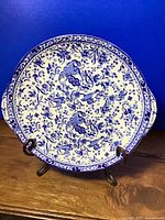 Top view of blue and white Burleigh Ware handled cake plate on stand