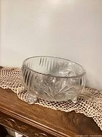 Side view of pinwheel cut crystal bowl on three feet