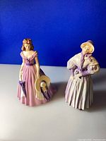 Both Goebel lady figurines front view