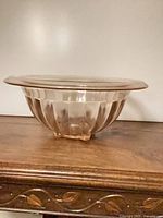 Side view showing ribbed body and three block feet