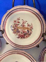 Close-up of one tea plate showing pattern and ribbed rim