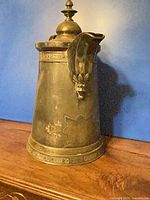 Side view focusing on engraved motifs and decorative banding at base