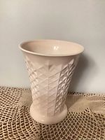 Full view of pink milk glass vase showing crosshatch pattern and flared rim