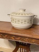 Covered serving dish side view with handles and lid