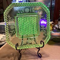 Platter on stand under UV light showing green fluorescence