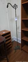 Full view of cast iron bridge arm floor lamp