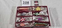 Open box showing eight blown glass candy ornaments