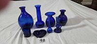 Group shot of all eight cobalt blue glass pieces