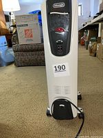 Front view of DeLonghi oil-filled radiator heater showing control panel and wheels