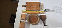 overview of all wooden kitchen items on table with ruler